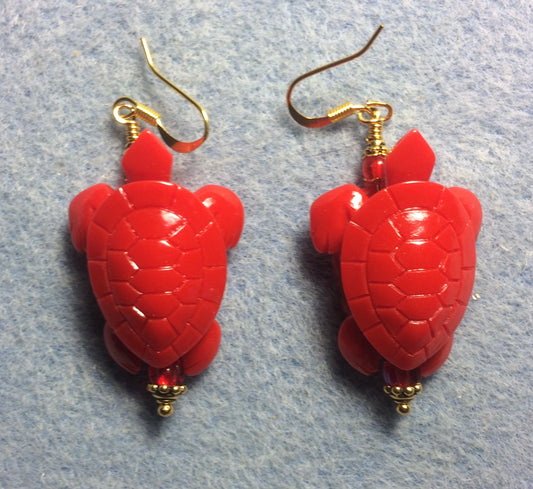 Large red reconstituted coral sea turtle bead earrings adorned with red Czech glass beads.