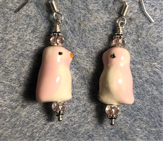 Pink and white ceramic penguin bead earrings adorned with pink Chinese crystal beads.