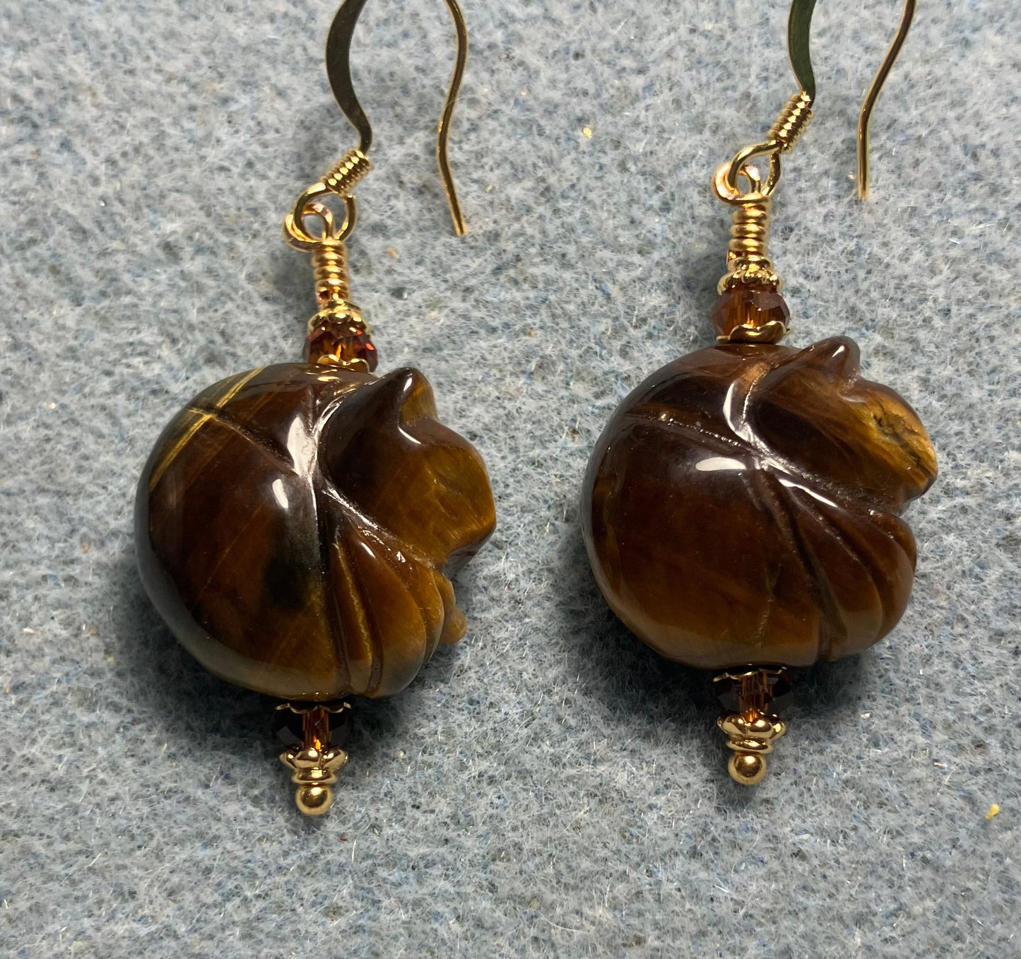 Tigereye gemstone sleeping cat bead earrings adorned with dark amber Chinese crystal beads.