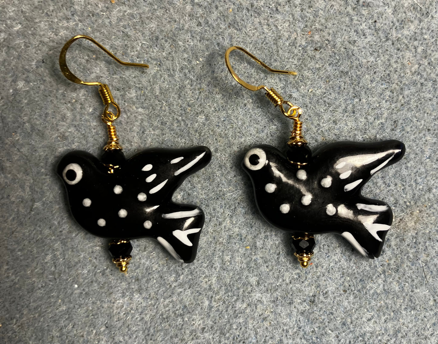 Large black and white ceramic spotted dove bead earrings adorned with black Chinese crystal beads.