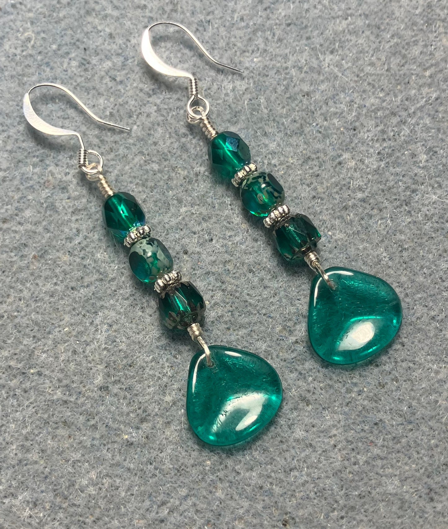 Translucent teal Czech glass rose petal earrings adorned with teal Czech glass beads.