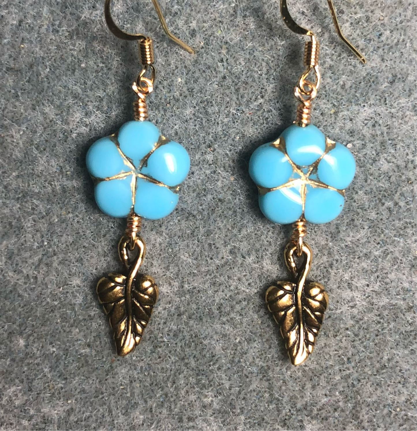 Turquoise (with gold inlay) Czech glass puffy flower bead earrings adorned with gold Tierracast leaf charms.