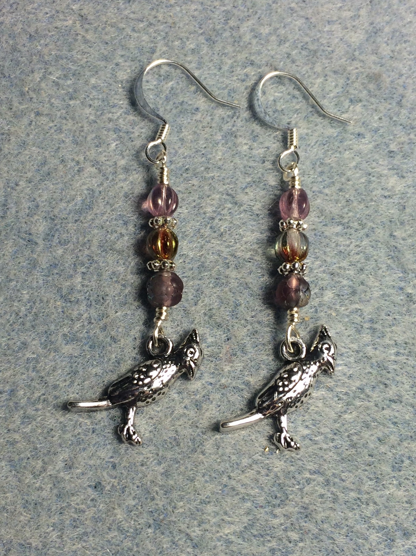 Silver cardinal charm earrings adorned with small violet Czech glass beads