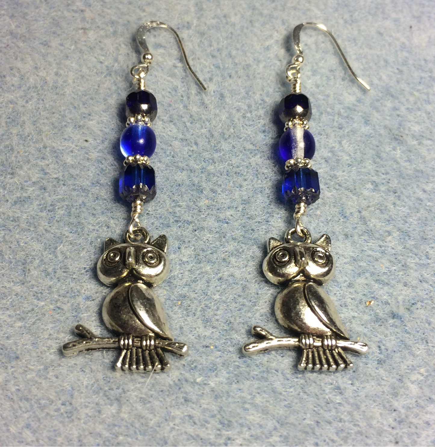 Silver owl charm earrings adorned with dark blue Czech glass beads