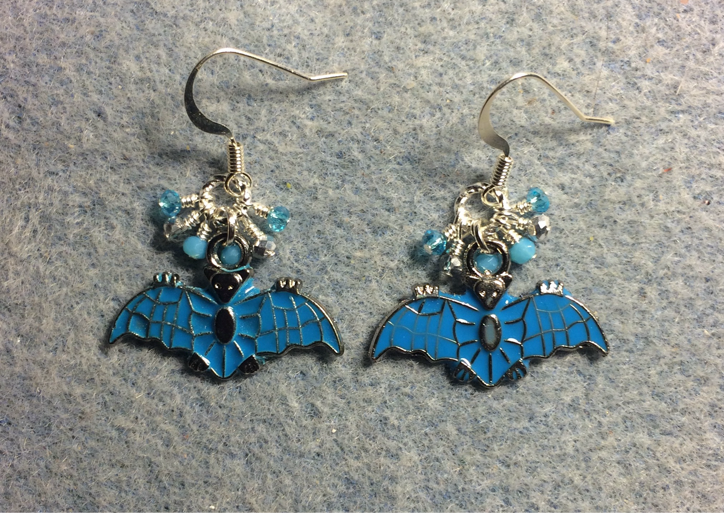 Turquoise and silver enamel bat charm earrings adorned with tiny dangling turquoise and silver Chinese crystal beads.