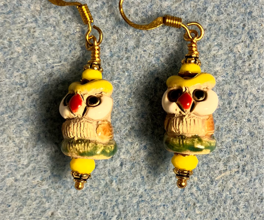 Small tan, yellow, and green ceramic owl bead earrings adorned with yellow Chinese crystal beads.