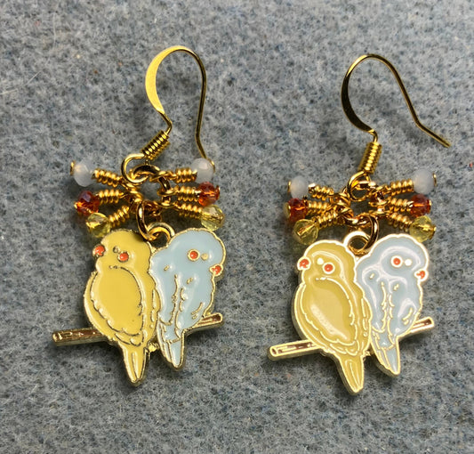 Yellow and light blue enamel pair of lovebird charm earrings adorned with tiny dangling yellow, light blue, and orange Chinese crystal beads.