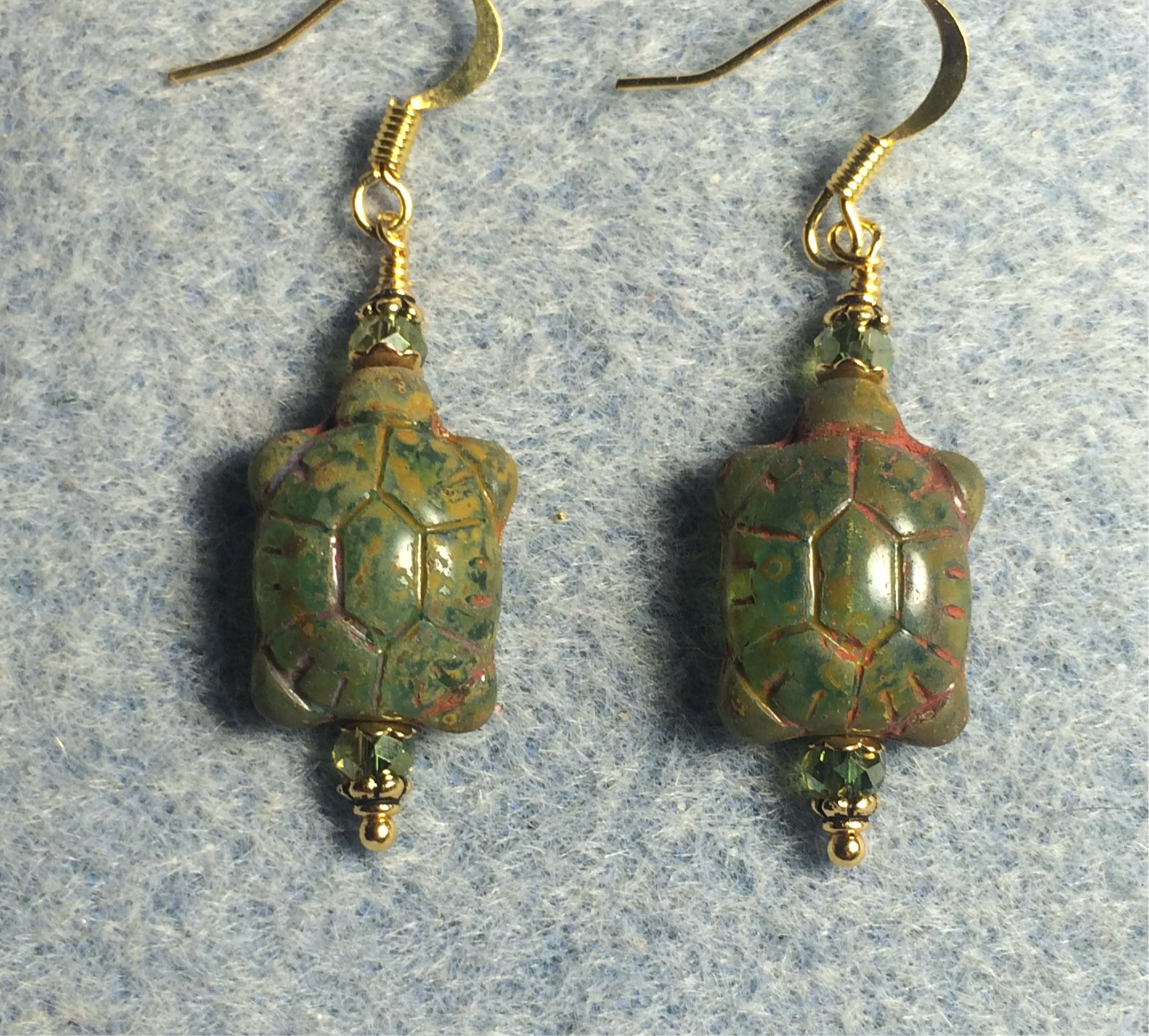 Green Picasso Czech glass turtle bead earrings adorned with green Chinese crystal beads.