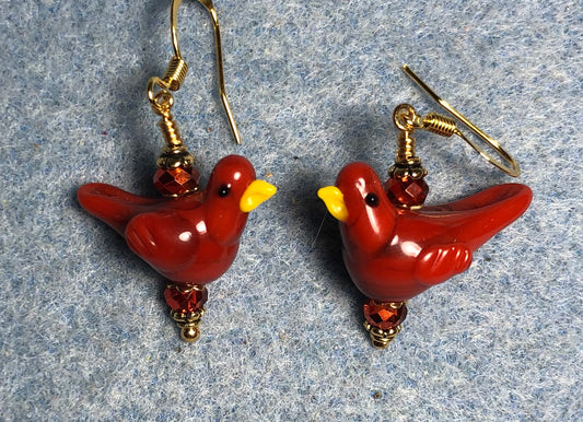 Opaque red orange lamp work songbird bead earrings adorned with red orange Chinese crystal beads.