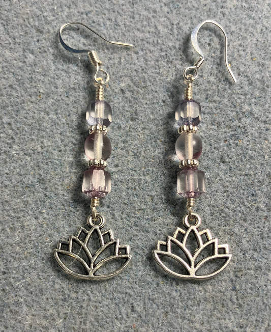 Silver lotus flower charm earrings adorned with light violet Czech glass beads.