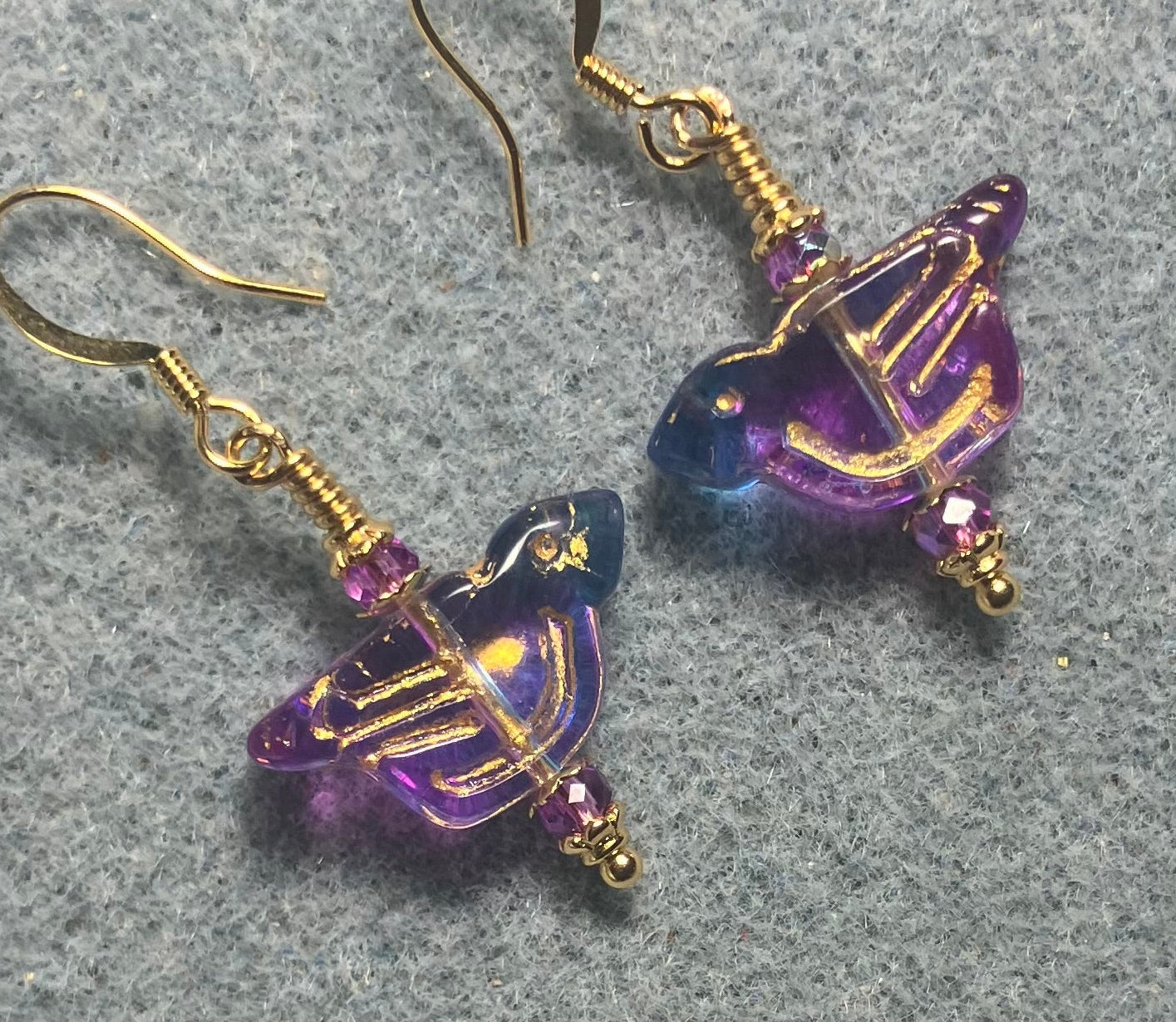 Translucent purple and turquoise (with gold wash) Czech glass bird bead earrings adorned with purple Chinese crystal beads.
