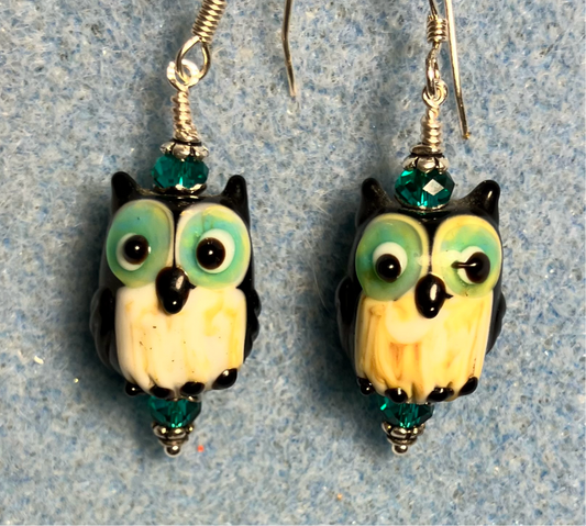 Teal, white, and black lamp work owl bead earrings adorned with teal Chinese crystal beads.