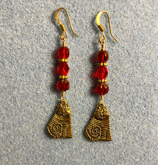 Gold sitting cat charm earrings adorned with red Czech glass beads