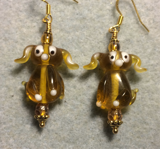 Translucent amber lamp work floppy eared puppy dog bead earrings adorned with amber Czech glass beads.