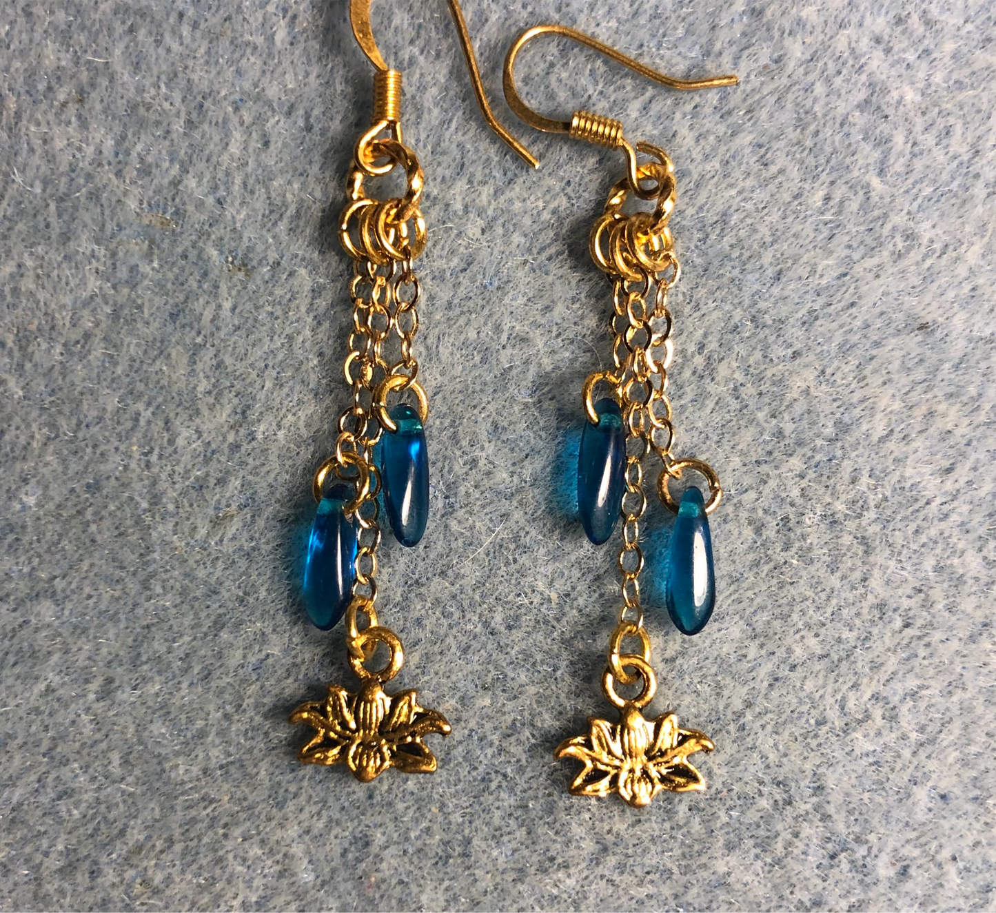 Small gold lotus flower charm earrings attached to gold chain and adorned with small turquoise Czech glass dagger beads