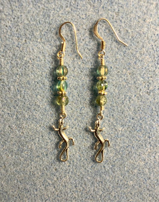 Tiny silver swirly tailed lizard charm earrings adorned with small green Czech glass beads