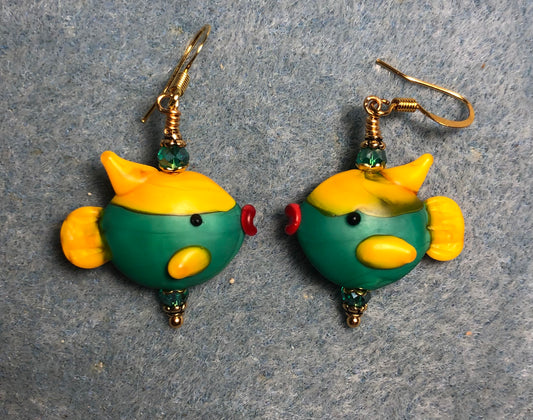 Teal and amber lamp work fish bead earrings adorned with teal Chinese crystal beads.