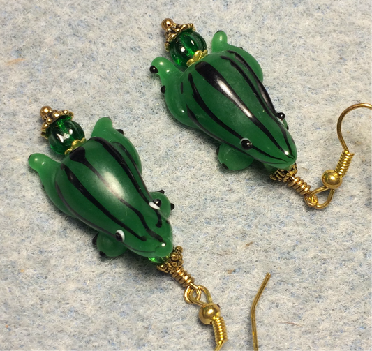 Emerald green with black stripes lamp work frog bead earrings adorned with emerald green Czech glass beads.