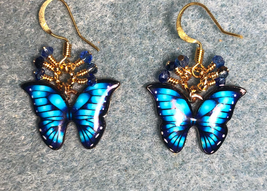 Blue and turquoise enamel butterfly charm earrings adorned with tiny dangling blue and turquoise Chinese crystal beads.