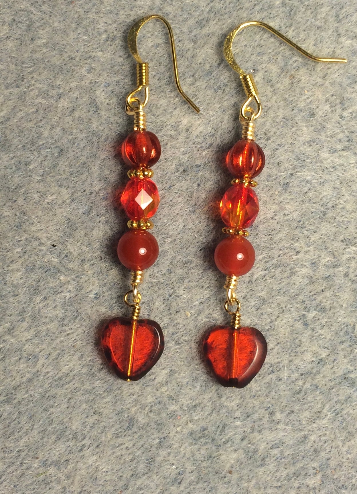 Small translucent orange Czech glass heart bead earrings adorned with orange Czech glass beads.