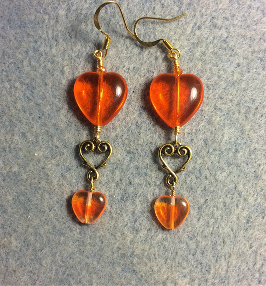 Large and small matching orange Czech glass heart bead earrings joined by gold Tierracast heart connectors.