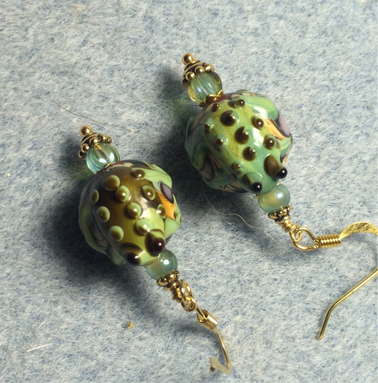 Green lamp work frog bead earrings adorned with green Czech glass beads.