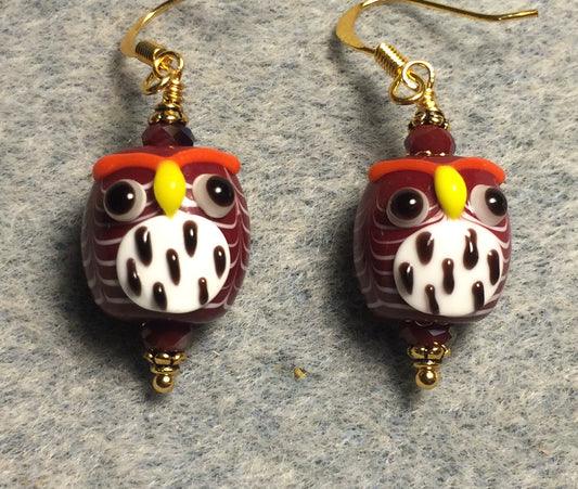Dark red and white lamp work spotted owl bead earrings adorned with dark red Chinese crystal beads.