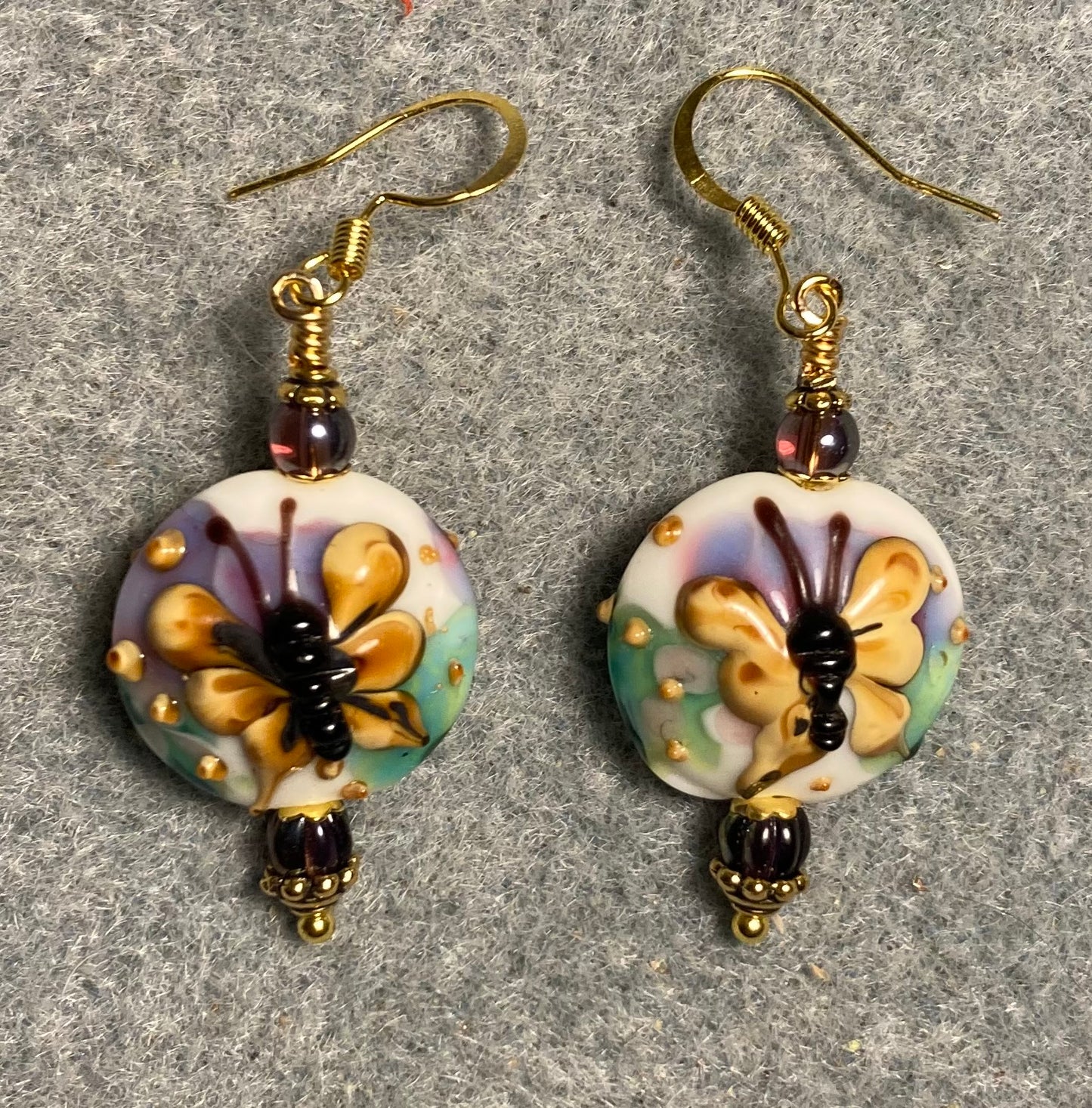 Purple and tan lamp work butterfly bead earrings adorned with purple Czech glass beads.