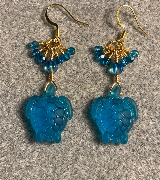 Translucent dark turquoise sea glass sea turtle bead earrings adorned with turquoise Czech glass beads and small dangling turquoise Czech glass beads.