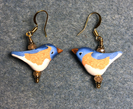 Blue, peach, and white polymer clay bird bead earrings adorned with peach Chinese crystal beads.