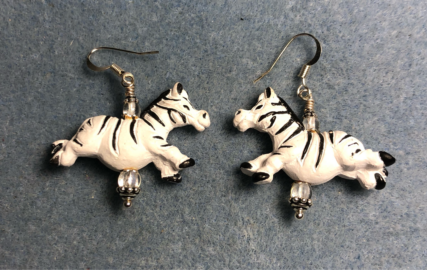 Black and white ceramic striped silly jumping zebra bead earrings adorned with clear Czech glass beads.