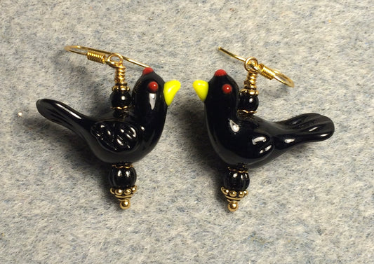 Opaque black lamp work songbird bead earrings adorned with black Czech glass beads.