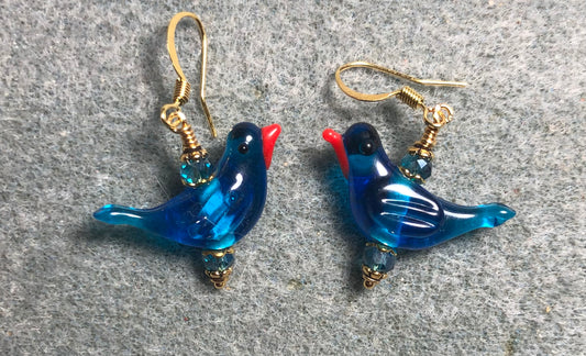 Translucent bright blue lamp work songbird bead earrings adorned with bright blue Chinese crystal beads.