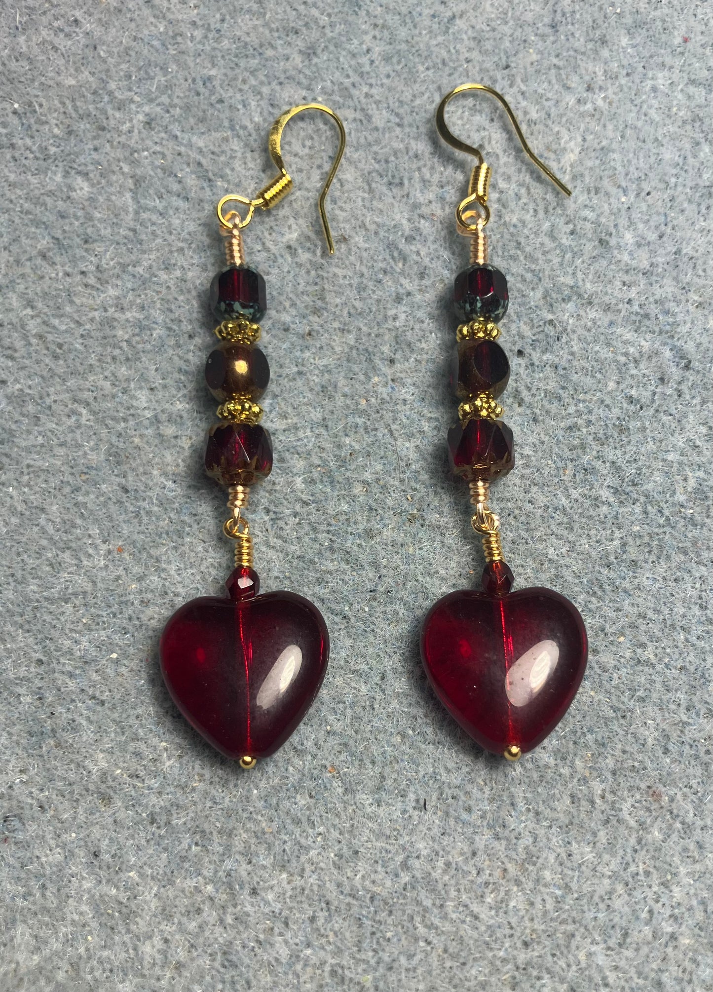 Ruby red Czech glass heart bead earrings adorned with ruby red Czech glass beads.