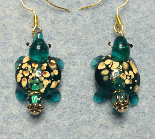 Translucent teal lamp work spotted turtle bead earrings adorned with teal Czech glass beads.