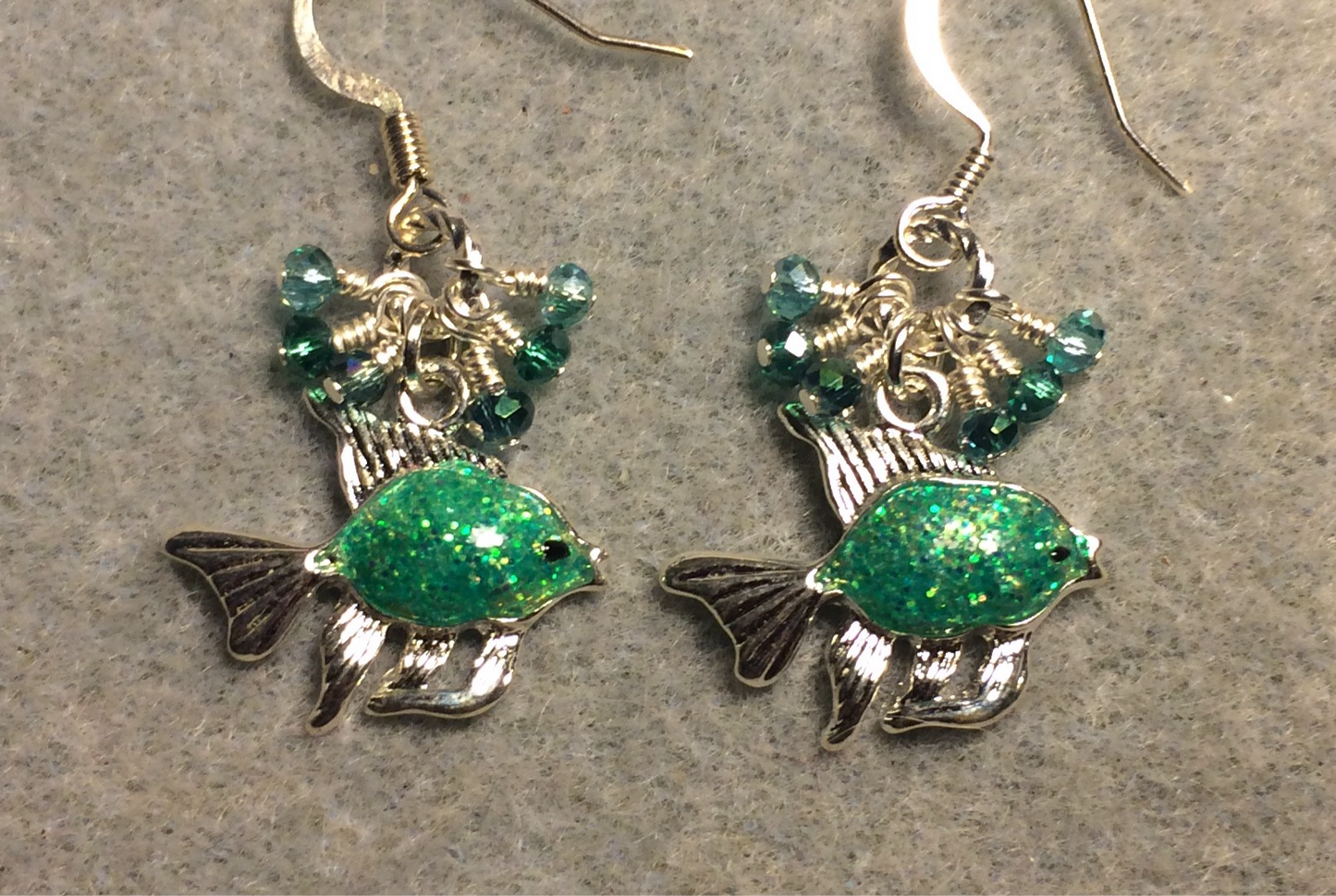 Sparkly turquoise enamel fish charm earrings adorned with tiny dangling turquoise and teal Chinese crystal beads.