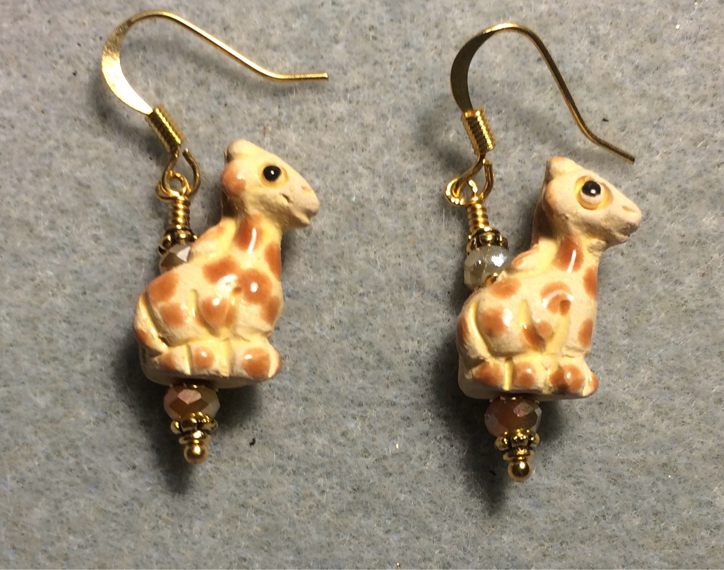 Small tan and orange ceramic spotted giraffe bead earrings adorned with tan Chinese crystal beads.