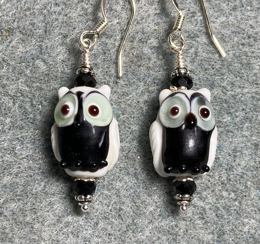 Black and white lamp work owl bead earrings adorned with black Chinese crystal beads.