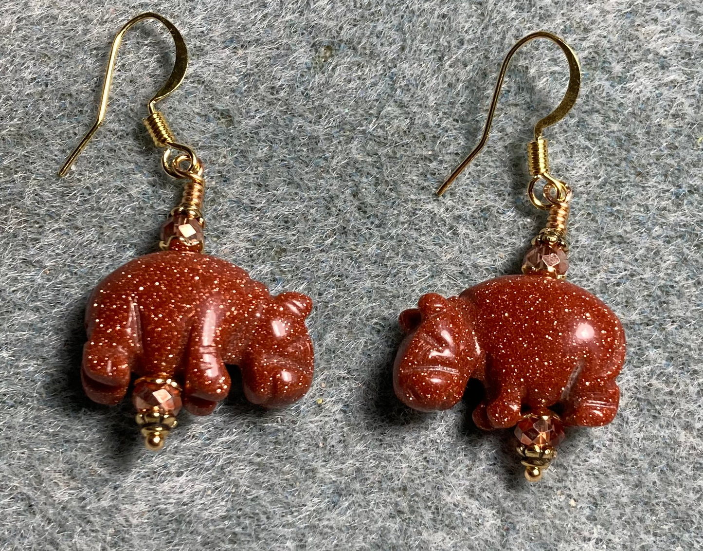 Orange goldstone gemstone hippo bead earrings adorned with orange Chinese crystal beads.