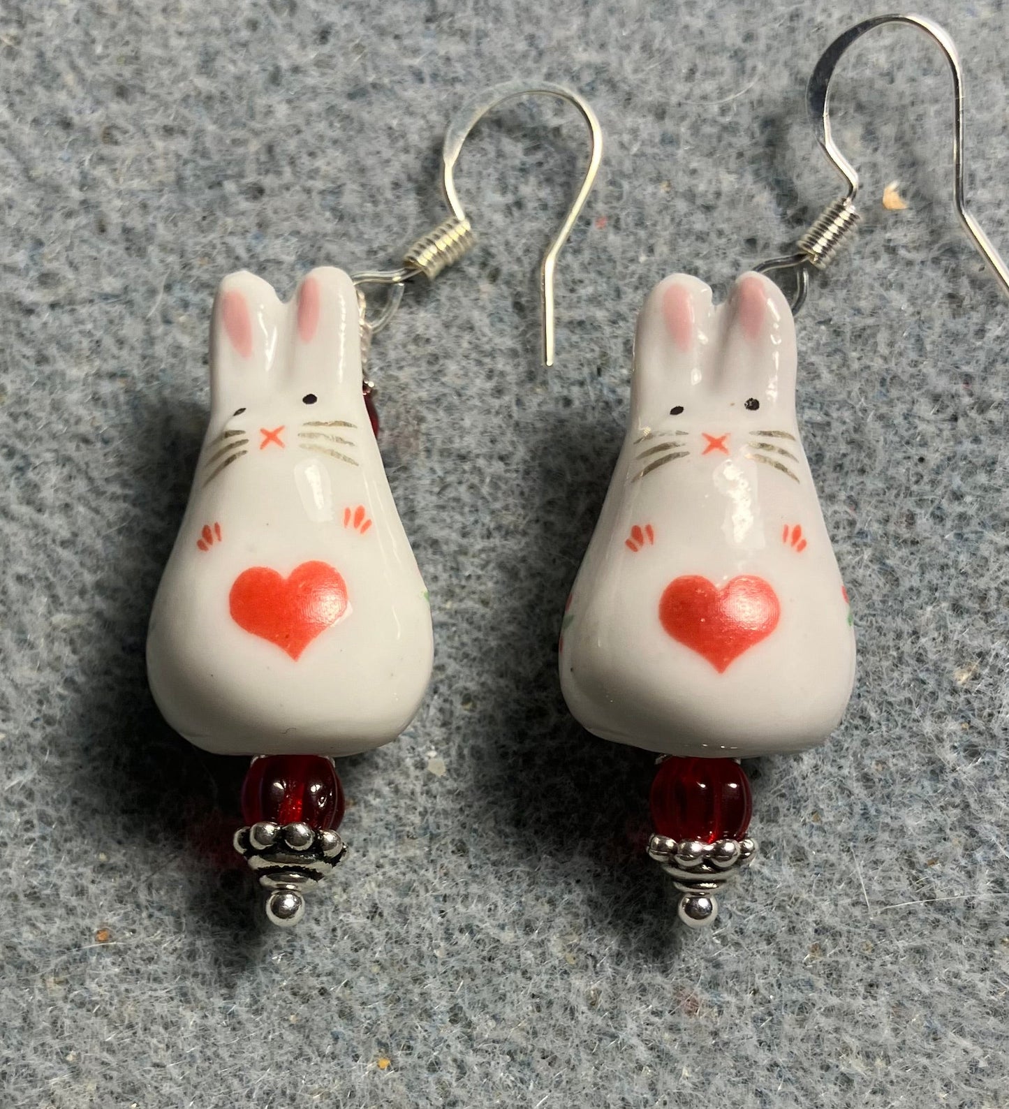 White and red ceramic bunny rabbit bead earrings adorned with red Czech glass beads.