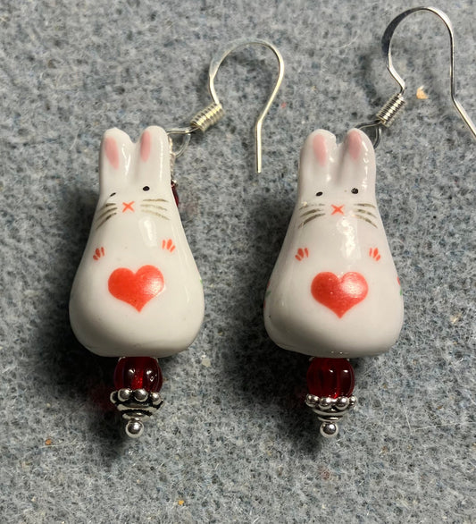 White and red ceramic bunny rabbit bead earrings adorned with red Czech glass beads.