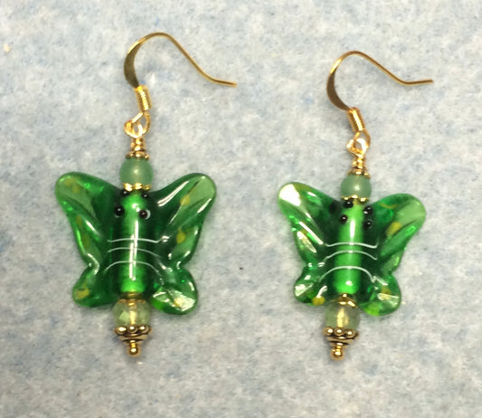 Emerald green lamp work butterfly bead earrings adorned with green Czech glass beads.