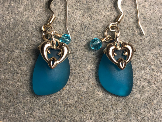 Small turquoise sea glass pendant bead earrings adorned with small silver dolphin charms and turquoise Chinese crystal beads.