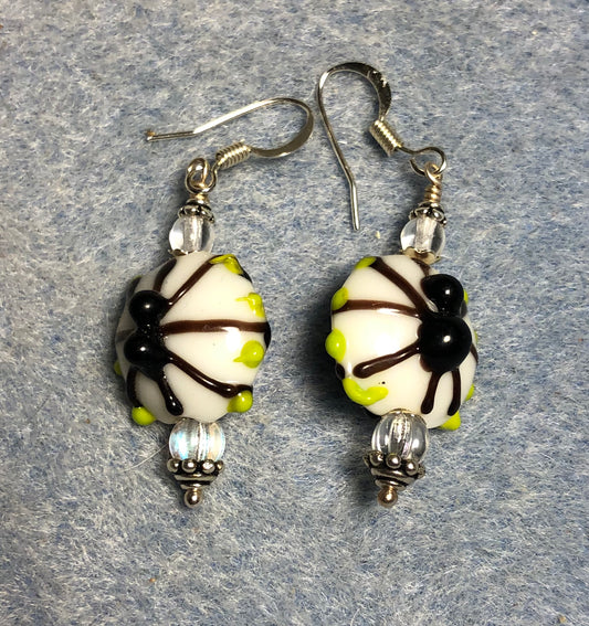 White and black lamp work spider bead earrings adorned with clear Czech glass beads.