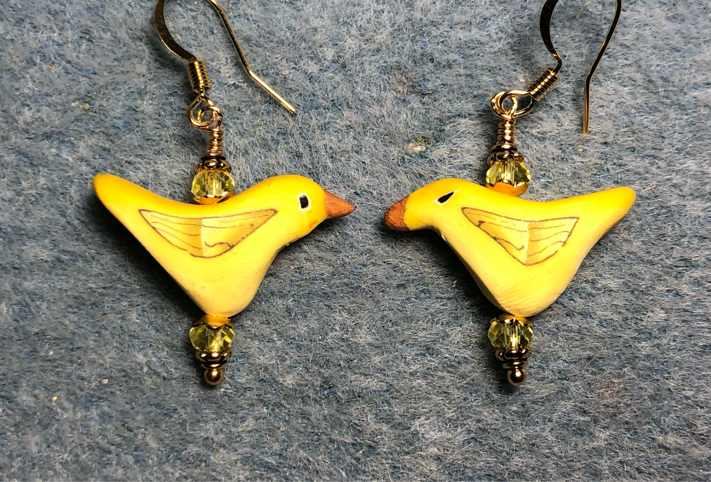 Yellow polymer clay bird bead earrings adorned with yellow Chinese crystal beads.