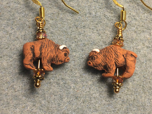 Small orange brown ceramic buffalo bead earrings adorned with small orange brown Chinese crystal beads.
