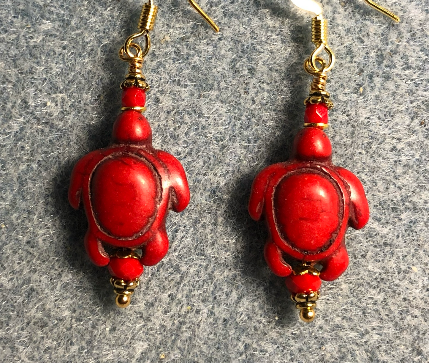 Red howlite gemstone turtle bead earrings adorned with red Chinese crystal beads.