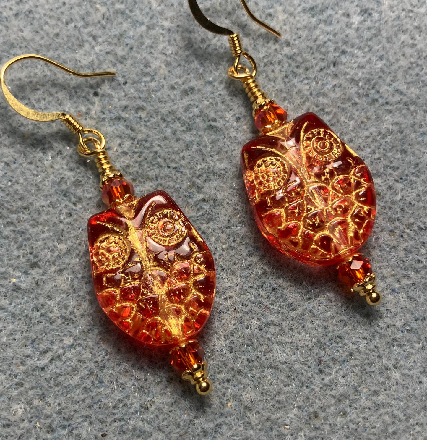 Sparkly orange (with gold wash) Czech glass owl bead earrings adorned with orange Chinese crystal beads.