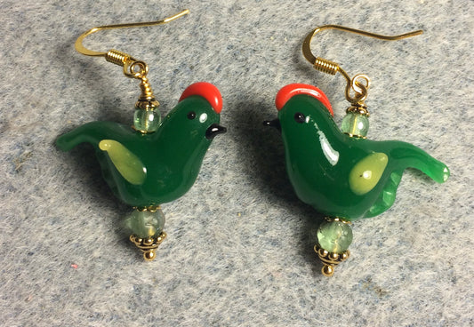 Opaque dark green and yellow lamp work songbird bead earrings adorned with green Czech glass beads.