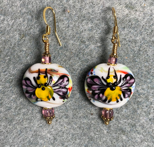 White, purple, and yellow lamp work butterfly bead earrings adorned with purple Czech glass beads.